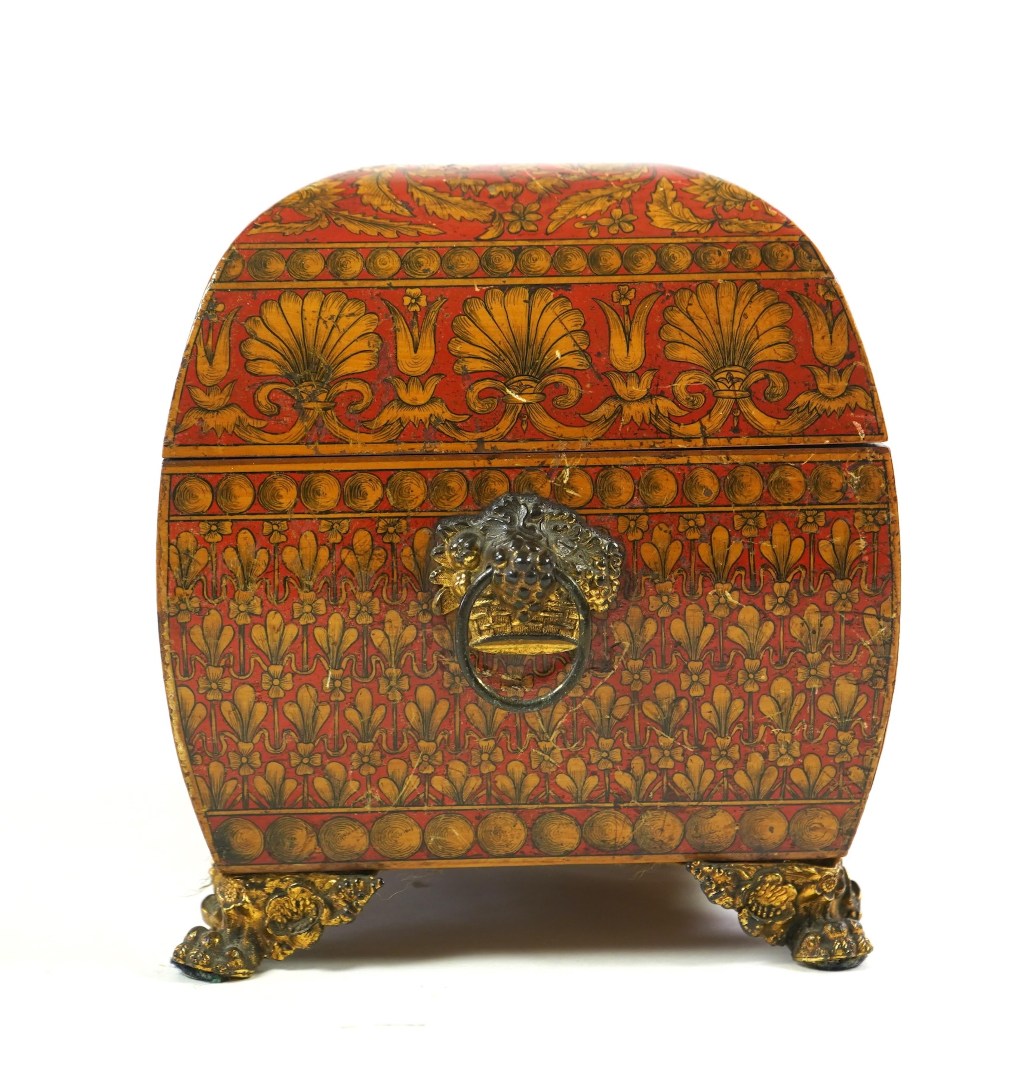A Regency red lacquer penwork tea caddy